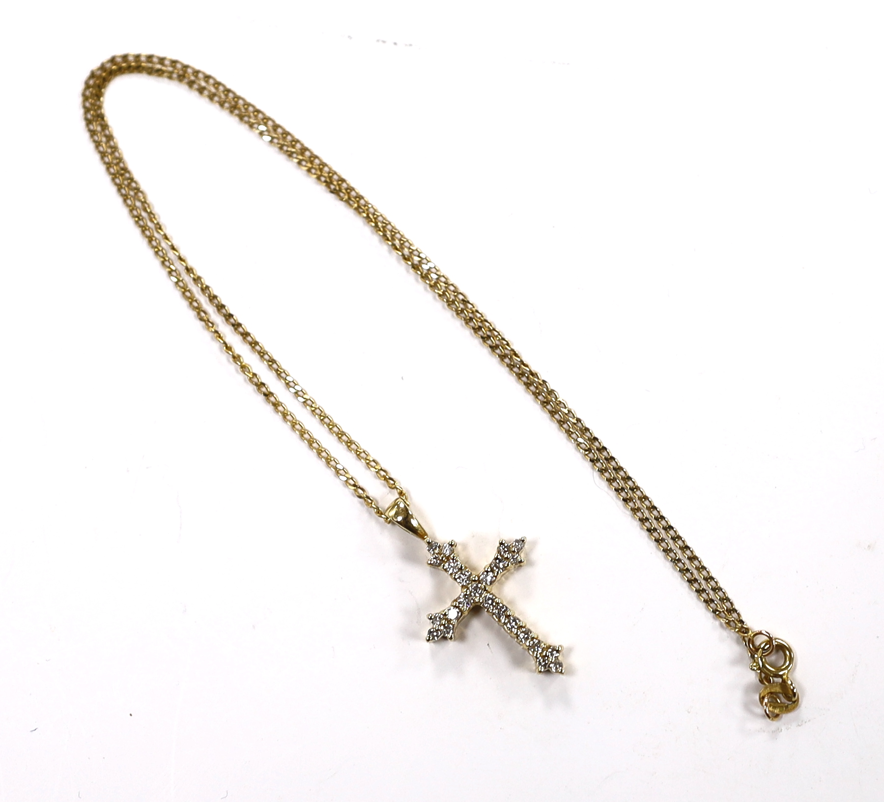 A modern 9ct gold and diamond chip set cross pendant, overall 30mm, on a 9ct gold chain, 40cm, gross weight 4.3 grams.